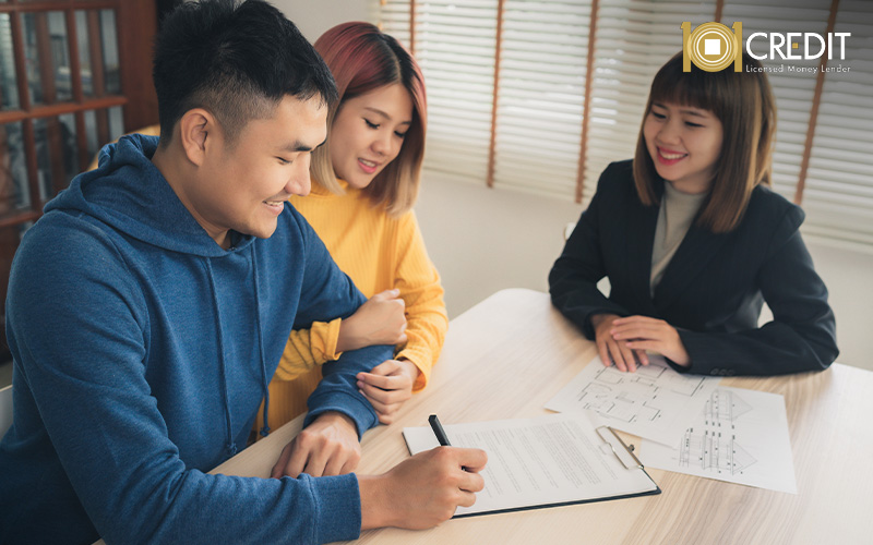 Couple signing a loan agreement with a financial consultant.