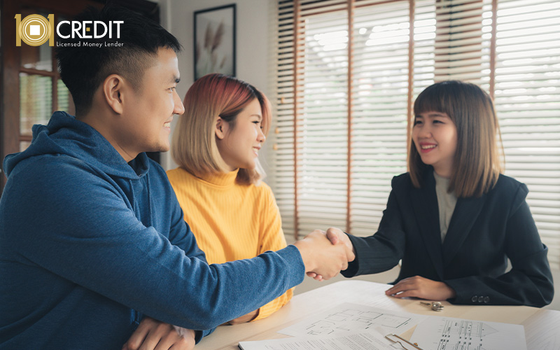 Man shaking hands with a consultant after loan approval.