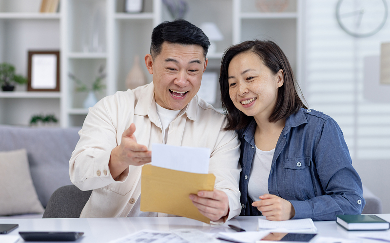 Couple looking happy while looking at the terms.