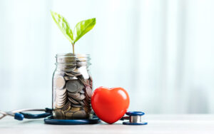 A jar filled with coins and a small plant growing out of it